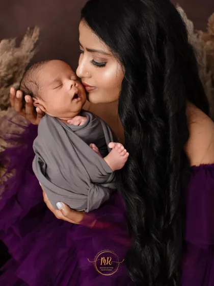 Another close-up from the mother and newborn session, showing the mother's gentle kiss on her baby's head.