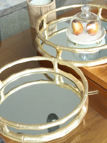A pair of our round bamboo-style mirror trays. The gold finish and unique frame design add a touch of Chinoiserie chic to your home, perfect for serving or styling.