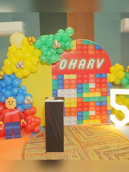 The amazing LEGO-themed decor for Dharv's 5th birthday, featuring a colorful brick backdrop and a giant LEGO man made of balloons.