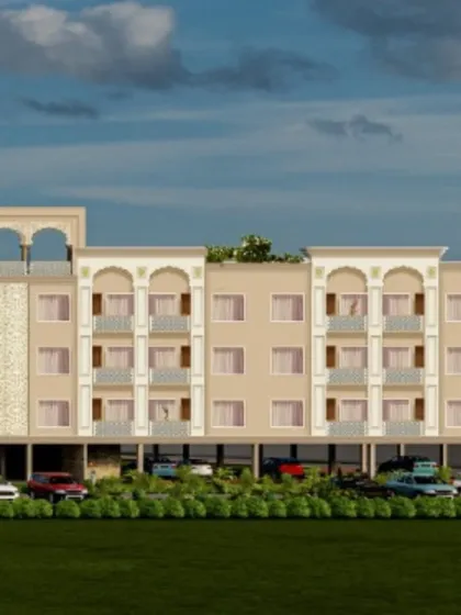 A wider perspective of the NRI Niwas project, showing the full scope of the building, its parking facilities, and the planned landscaping that will surround it.