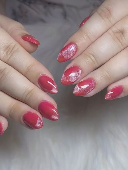 A lovely red manicure with a "cat eye" effect creating a silver shimmer in the center of each nail.
