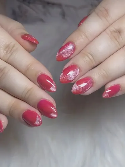 A lovely red manicure with a "cat eye" effect creating a silver shimmer in the center of each nail.