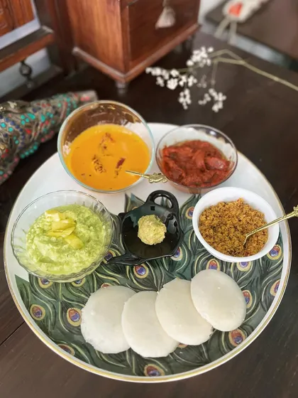 A perfect breakfast platter featuring soft idlis served with a variety of my chutneys and podis. You can see how the deep colour of the Chammanthi Podi offers a delicious contrast to the other accompaniments, proving it has star billing in any South Indian meal.