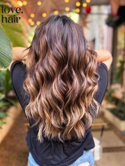 A classic sun-kissed balayage. We added warm, golden highlights to create a natural, beachy look that seems like it was lightened by the sun itself.