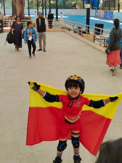 Our young champion Rayaansh, full of spirit and pride, holding the Karnataka flag after a competition.