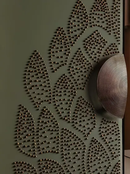 Some spaces are meant to be discovered in the details. This close-up shows a custom cabinet door with intricate brass stud detailing, a whisper of the craftsmanship and texture that defines our work.