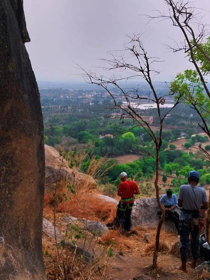 A group of climbers enjoying the view from the top of a crag. The breaks between climbs are perfect for soaking in the scenery and catching up with friends.