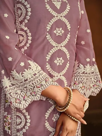 This mauve organza Anarkali is soft and dreamy. The detailed thread embroidery on the hem and sleeves gives it a delicate, handcrafted feel.