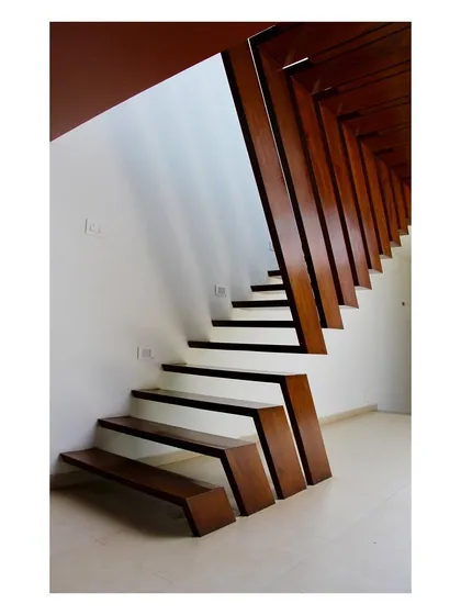 In the "Boxed In House," we crafted this staircase from teakwood recycled from the original structure on the site. This detail exemplifies our commitment to sustainable practices and material innovation, turning a functional piece into a central design feature.