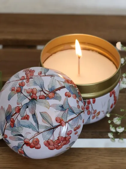 A minimal scented candle in a tin with a delicate berry print. Housed in a sleek, understated jar, it’s a quiet statement of elegance for any corner of your home.