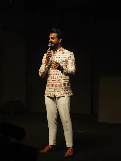 Addressing the audience during a Sangeet night. My focus is always on keeping the crowd engaged and entertained throughout the evening.