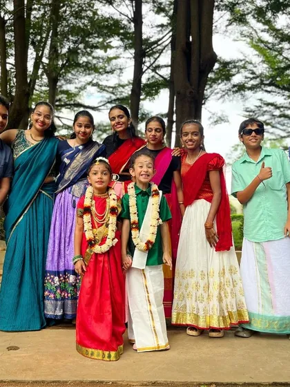 The whole dance family together in traditional wear. This photo captures the spirit of our studio, where we celebrate culture, friendship, and the joy of performance as one big team.