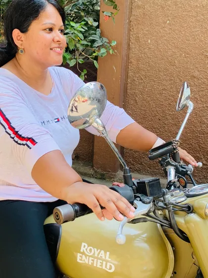 A graduate enjoys a quiet moment on her bike. The confidence she has gained is evident in her relaxed posture.