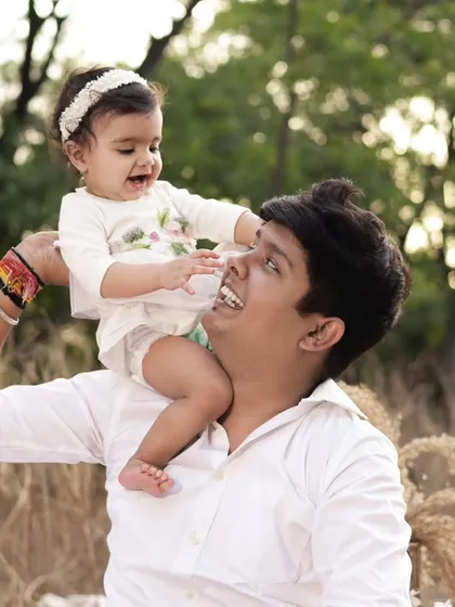 A heartwarming shot of a father with his daughter on his shoulders. These candid, playful moments are a beautiful part of our outdoor family and birthday sessions.
