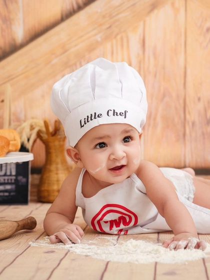 This tiny chef is exploring the textures of flour, a sensory experience that makes for beautiful, authentic photographs.