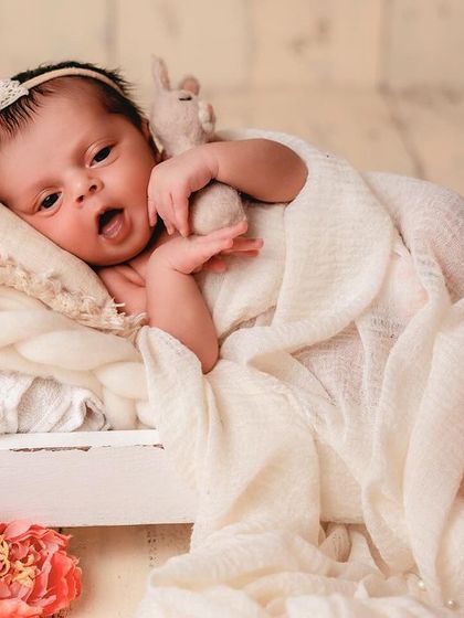 A sweet, expressive face from a baby lying in a tiny bed prop. It's wonderful to capture their personality as they look around and take in their new world.