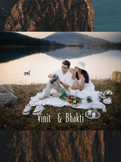 A serene lakeside picnic setup for a pre-wedding shoot, showcasing a quiet, intimate moment as the couple enjoys the scenery.