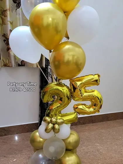 A 25th anniversary or birthday balloon bouquet in gold and white.