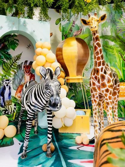 A collection of animal figures, including a zebra, giraffe, and deer, arranged with balloon art for a fun and dynamic safari scene.