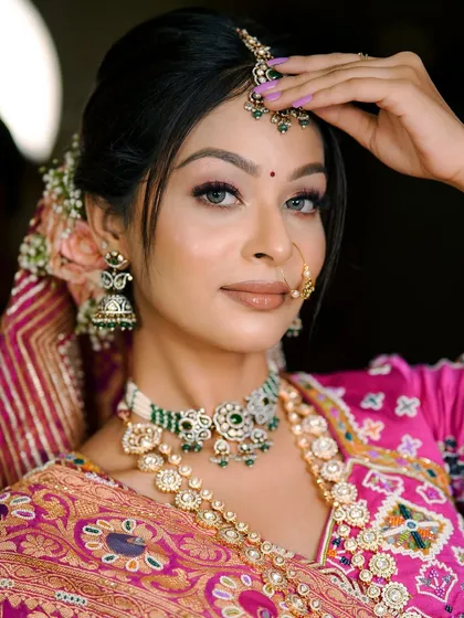 A close-up of the Gujarati bridal look, focusing on the intricate jewelry and the soft, glowing makeup.
