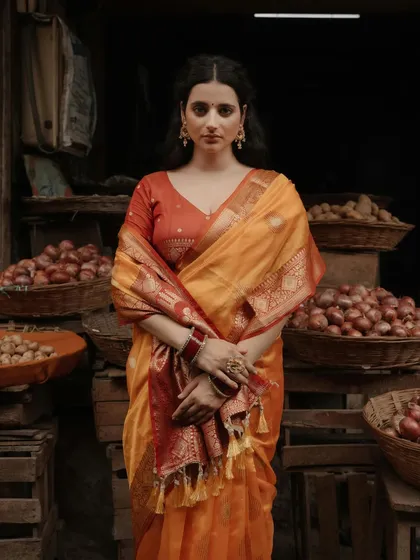 A portrait that feels like a scene from a classic film. Set in a rustic Varanasi market, this image captures a timeless elegance, blending traditional attire with an authentic, story-rich environment.
