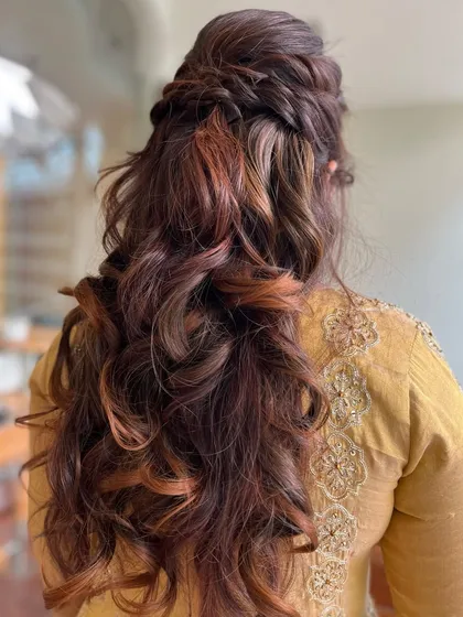 The full back view of the twisted half-updo, a great style for a bridesmaid or wedding guest.