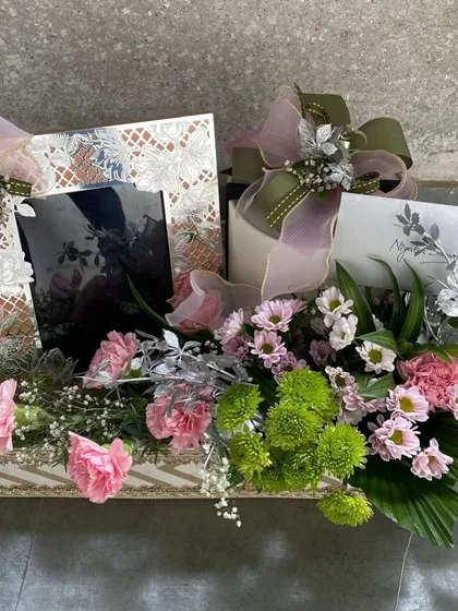 A closer look at a bespoke wedding hamper, featuring our elegant photo frames and other keepsakes. Each one is thoughtfully packaged with luxe items and personalized touches to celebrate the special day.