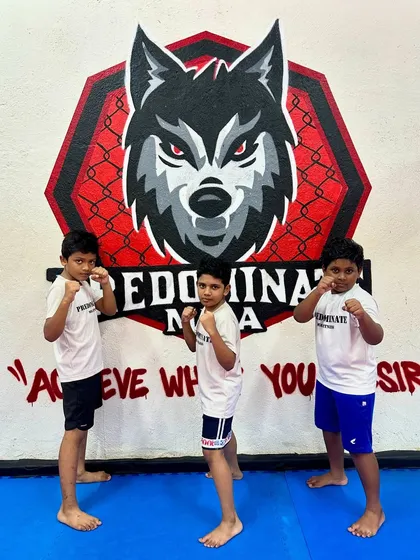 Let your kids become heroes in martial arts. Three young students stand in a fighting stance, ready to train.