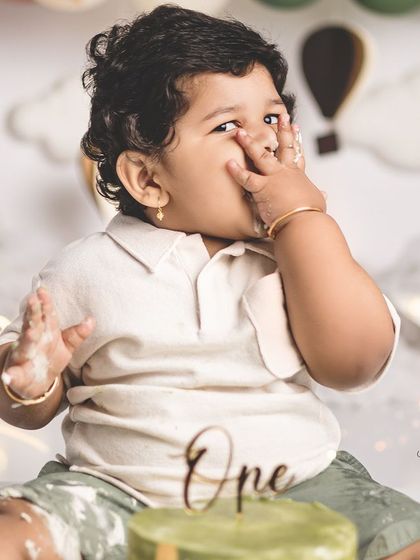 A funny face from the birthday boy during his cake smash! These candid moments are often the most cherished.