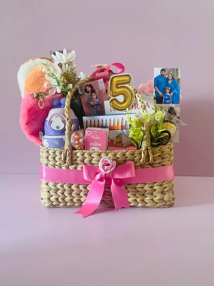 The personalized 5th birthday basket, complete with a number "5" balloon candle and custom photos.