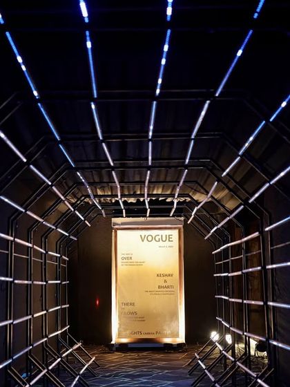 A futuristic entrance tunnel made of blue LED light strips, creating a high-impact and memorable arrival experience for guests.