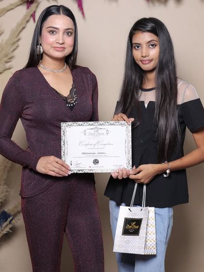 A proud moment for a student as she receives her professional makeup artistry certificate.