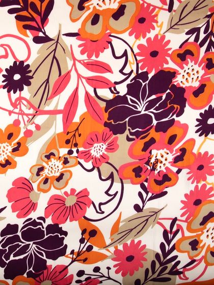 A full-frame shot of a vibrant floral fabric, capturing the entire pattern repeat.
