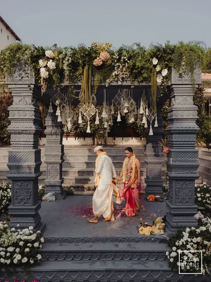 A grand South Indian wedding ceremony, with the couple taking their first steps as one. We specialize in capturing the scale and sanctity of traditional rituals against stunning architectural backdrops.