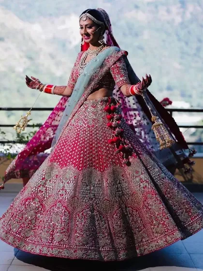 A radiant bride twirls in her magnificent pink and silver lehenga. We created a complete bridal look with hair and makeup that complemented her intricate outfit and ensured she felt joyful and confident on her wedding day.