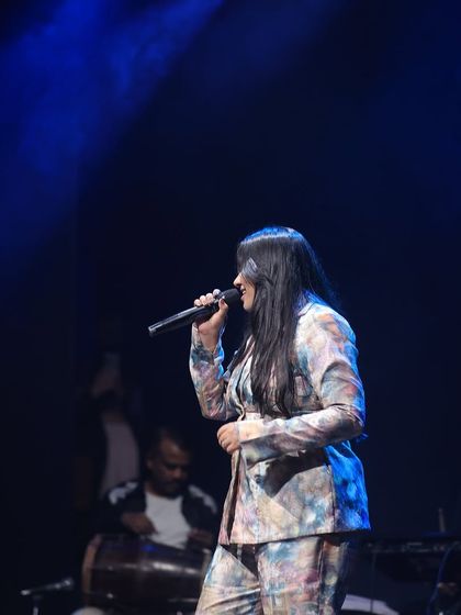 Another moment from my performance, with the dholak player in the background. The live band adds so much energy to the concert experience for our students.