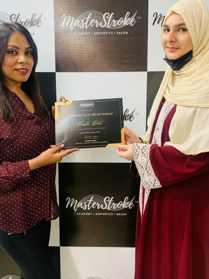 The best moment is seeing my students achieve their goals. Here, a graduate receives her Certificate in the Art of Makeup, ready to start her professional journey. My goal is to empower you with the skills and certification you need to succeed.