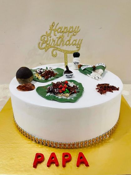 A side view of the unique Paan-themed cake, showing the clean finish and gold border.
