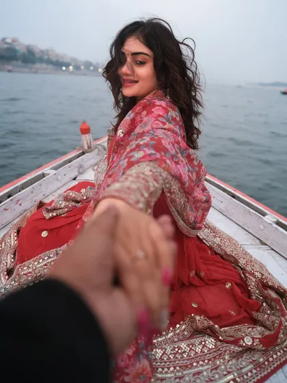 A smile that holds the magic of Varanasi. This candid moment on a boat captures the joy and romance of a couple's journey on the sacred Ganga.