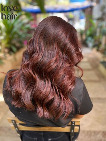 A side view of the cherry cola hair, showing the beautiful, soft waves and the rich, multi-tonal red.