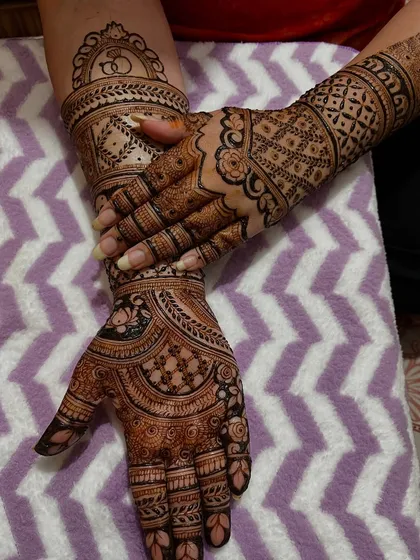 Another pose showing the front and back of the hands. The designs are coordinated to create a complete and beautiful look.