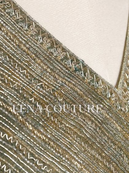 I designed this sage green raw silk blouse with geometric handwork for a timeless yet modern feel. The linear beadwork is complemented by custom floral tassels, making it a versatile piece for any occasion.