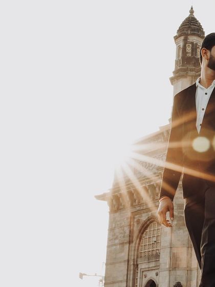 A stylish shot of the groom-to-be against the backdrop of the Gateway of India at sunrise.