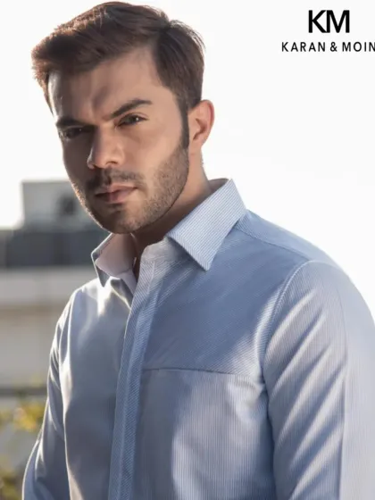 A light blue shirt with a subtle texture. This is a versatile staple for any wardrobe, tailored for a crisp, refined look.