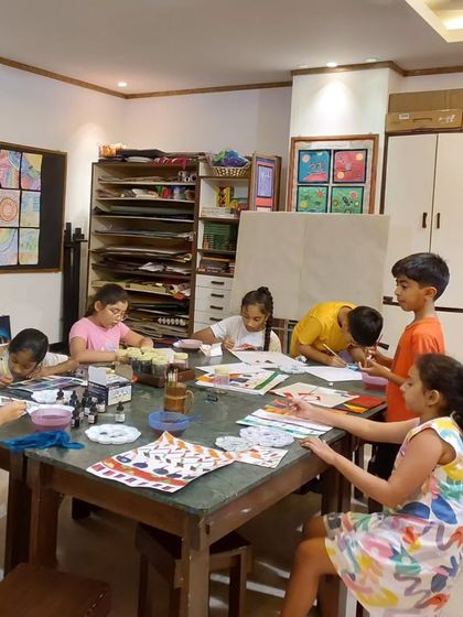 Our Saturday class for older children is a hub of focused creativity. Here, students are working on intricate patterns, fully absorbed in their art.