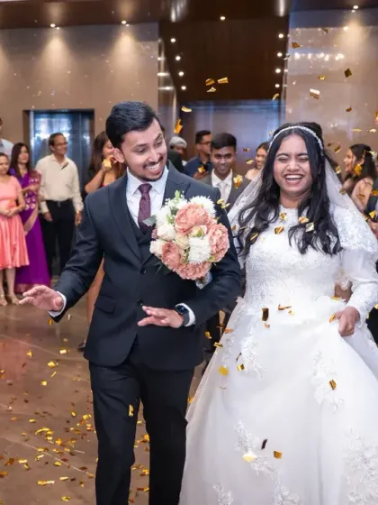 The grand exit from the ceremony and entrance to the reception, showered with confetti by friends and family. The smiles on their faces say it all.