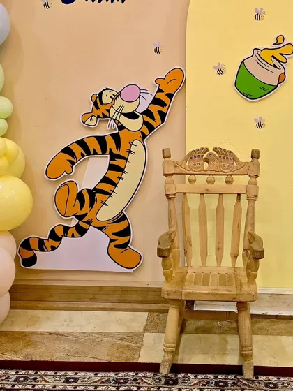A close-up of the Tigger cutout and the special wooden chair for the birthday boy from the Winnie the Pooh setup.