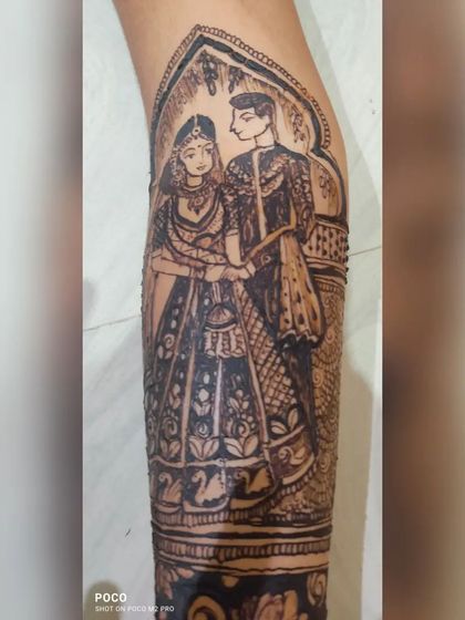 Sometimes the story continues on the arm. I created this incredibly detailed, realistic portrait of a couple as a central part of the bride's full-sleeve henna design.