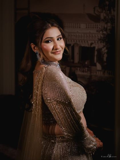 A lovely side profile of the bride, with her high ponytail and glamorous makeup on full display.