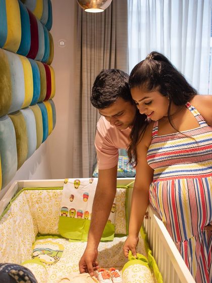 A beautiful lifestyle shot of a couple in their baby's nursery, looking at the crib together. This is a wonderful way to capture the anticipation in your own space.